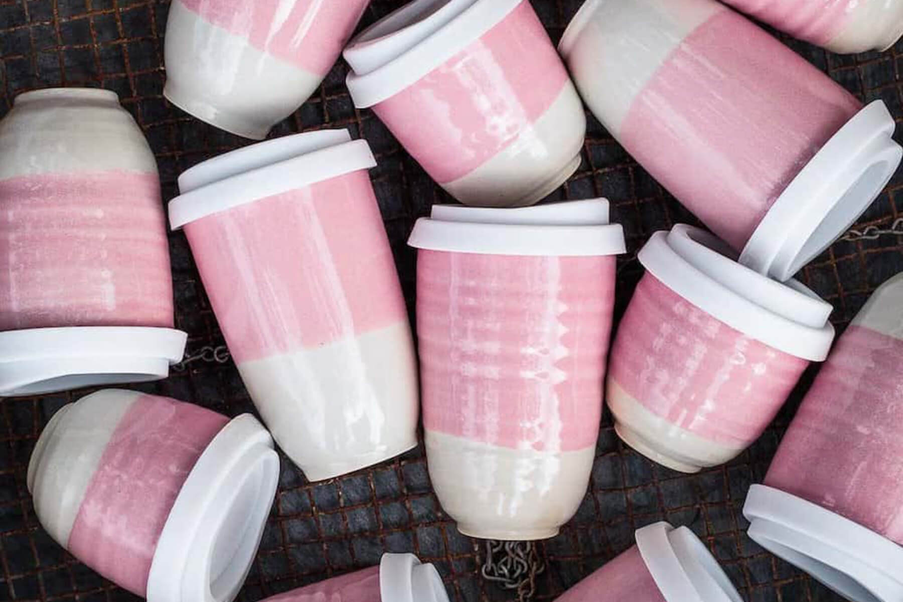 A dozen pink and white reusable cups
