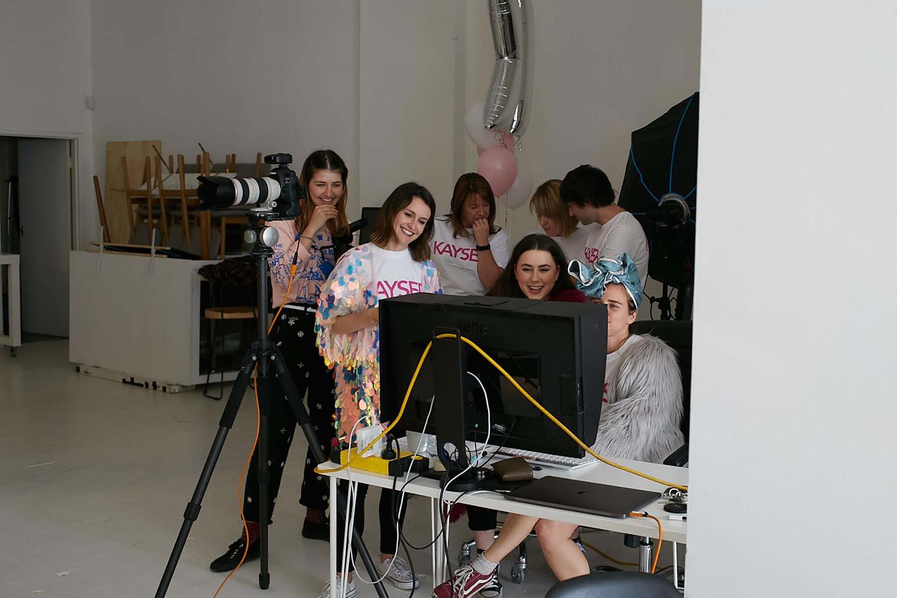 Amy Willows and team looking at photographs at photo shoot