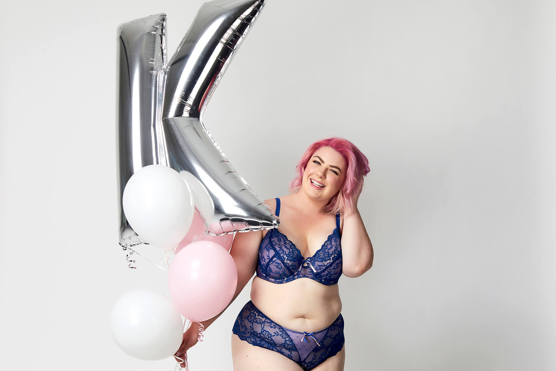Amy Willows wearing lingerie, holding balloons