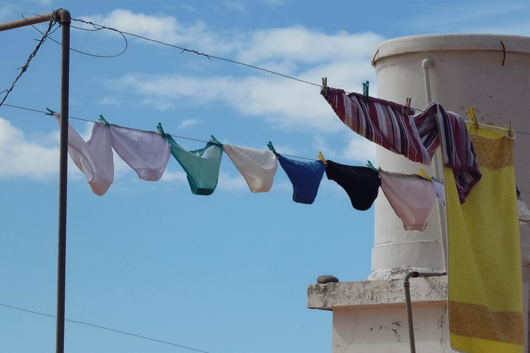 Multiple pairs of underwear hanging on clothes line outside