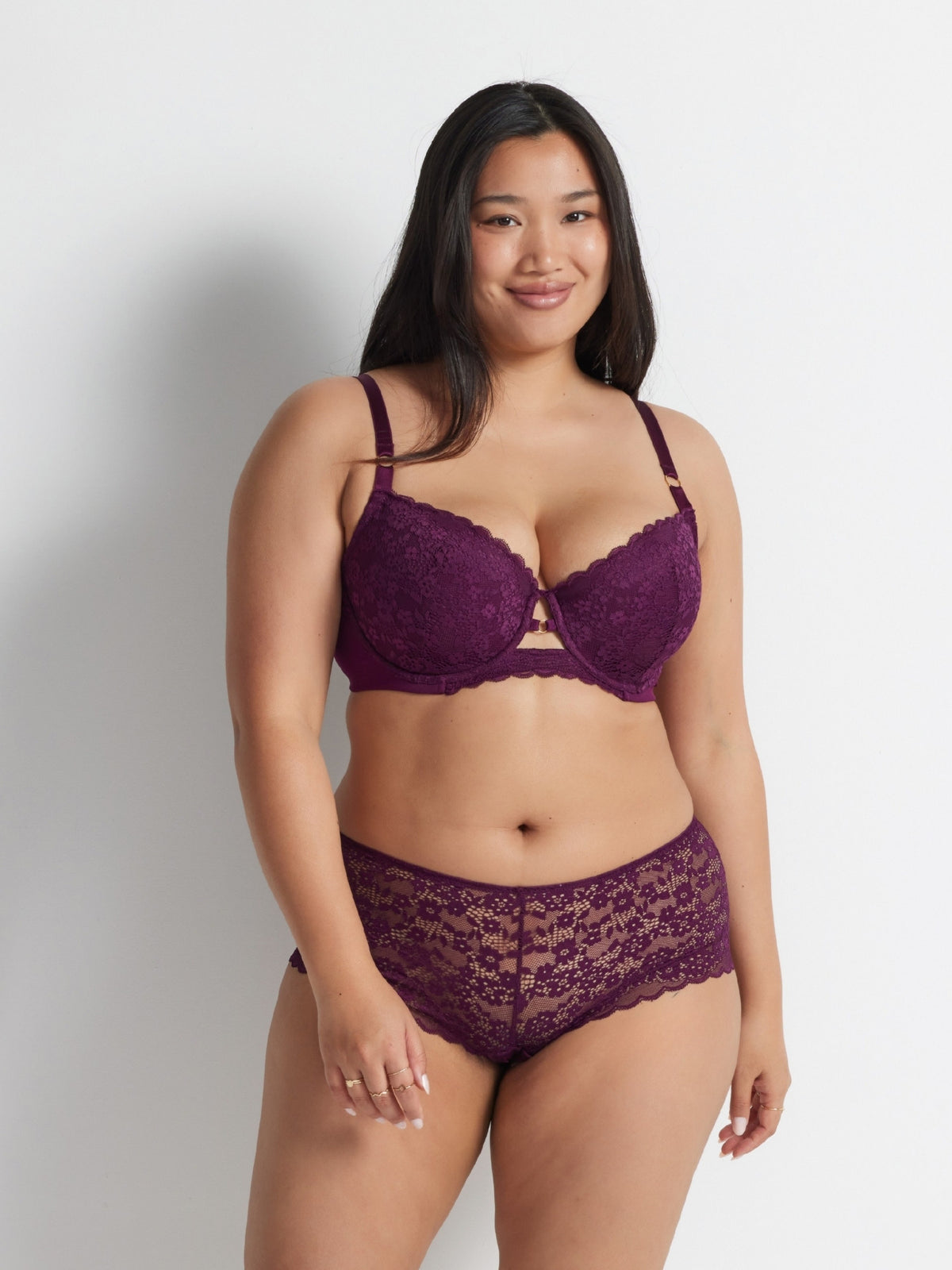 Burgundy lace balconette bra and matching briefs set worn against a light background.